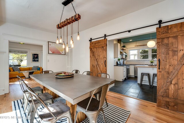 2855 Post St, Jacksonville, FL 32205 - dining room featuring a barn door and dark wood finished floors