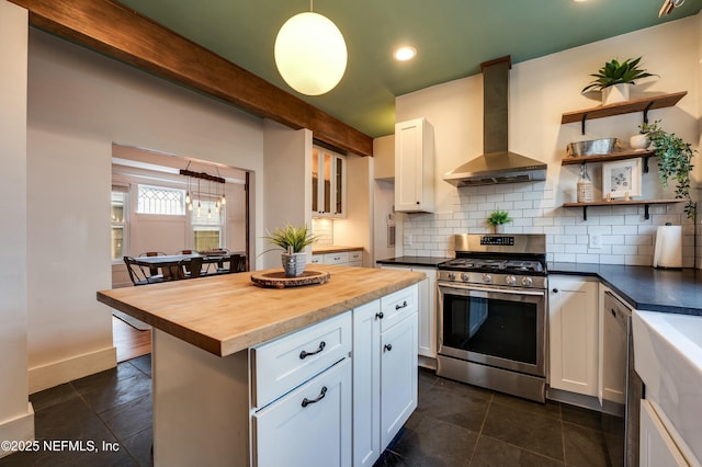 2855 Post St, Jacksonville, FL 32205 - kitchen with white cabinetry, wall chimney exhaust hood, tasteful backsplash, appliances with stainless steel finishes, and butcher block counters