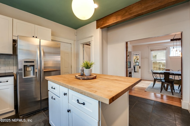 2855 Post St, Jacksonville, FL 32205 - kitchen featuring stainless steel fridge, tasteful backsplash, a center island, wooden counters, and white cabinets