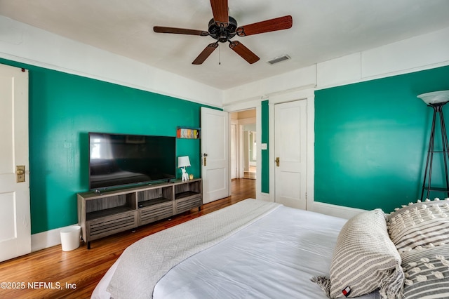 2855 Post St, Jacksonville, FL 32205 - bedroom with visible vents, wood finished floors, and a ceiling fan