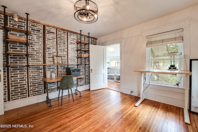 2855 Post St, Jacksonville, FL 32205 - unfurnished office featuring hardwood / wood-style floors, an inviting chandelier, and brick wall