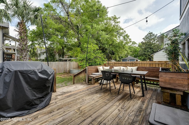 2855 Post St, Jacksonville, FL 32205 - wooden deck featuring a grill, outdoor dining area, and a fenced backyard