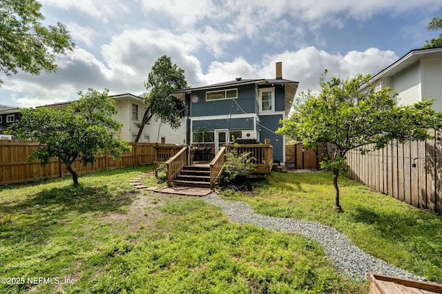 2855 Post St, Jacksonville, FL 32205 - rear view of property with a chimney, a fenced backyard, a yard, and a deck