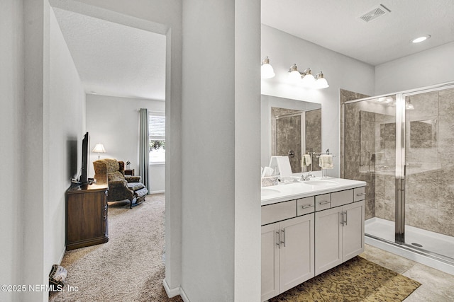 12424 Shady Bridge Trl, Jacksonville, FL 32258 - full bathroom with vanity, a stall shower, a textured ceiling, connected bathroom, and visible vents
