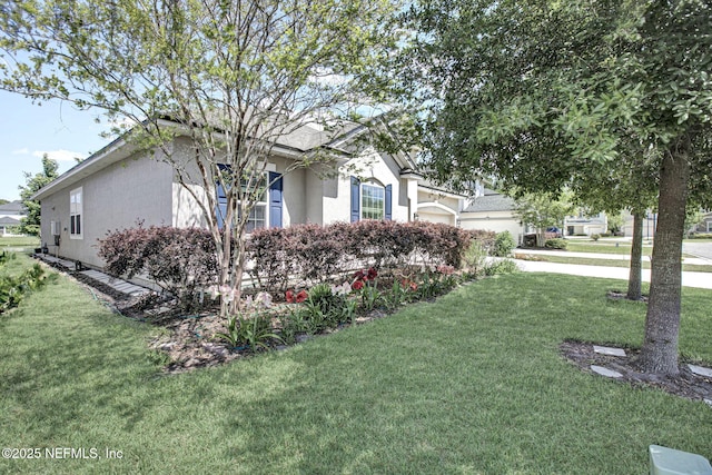 12424 Shady Bridge Trl, Jacksonville, FL 32258 - view of property exterior with an attached garage, concrete driveway, stucco siding, and a lawn