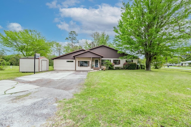 view of front facade with an outbuilding, a front lawn, and a storage shed