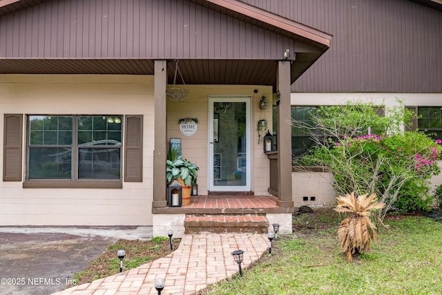 doorway to property featuring covered porch