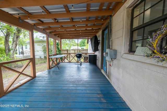 wooden terrace featuring fence
