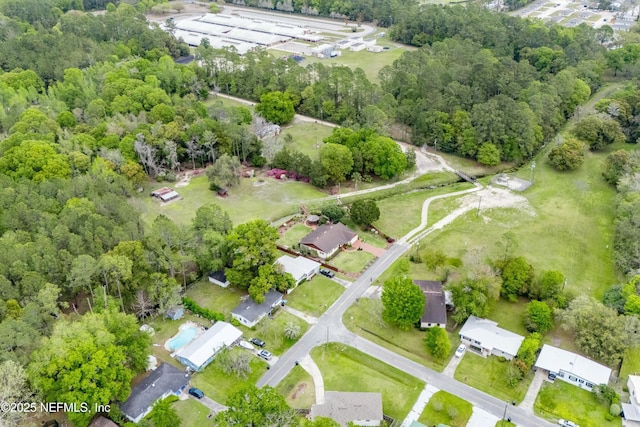 bird's eye view featuring a wooded view