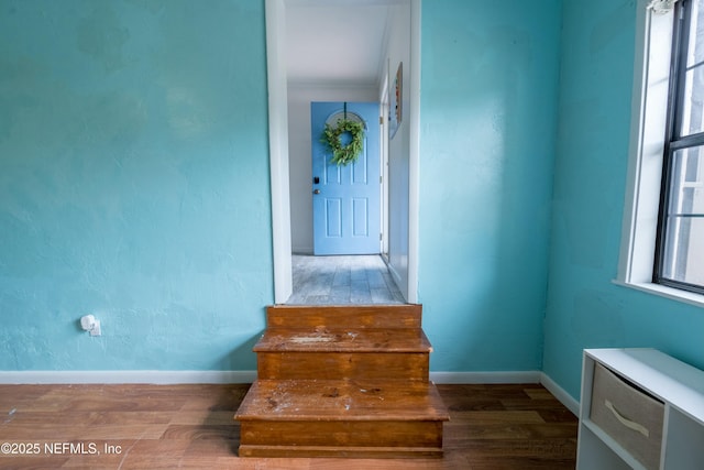 staircase with baseboards and wood finished floors