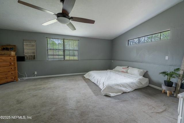bedroom with baseboards, carpet flooring, vaulted ceiling, and multiple windows