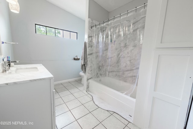 bathroom with tile patterned floors, toilet, vanity, shower / washtub combination, and baseboards
