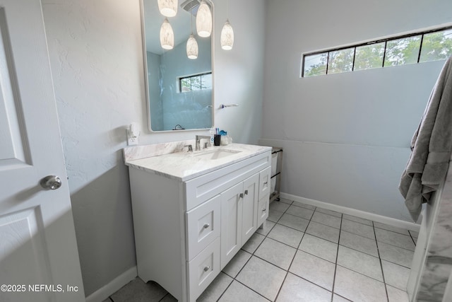 bathroom with tile patterned floors, vanity, and baseboards