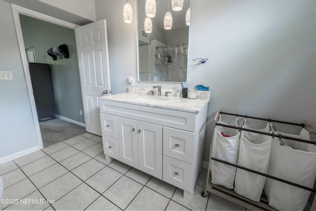 full bathroom featuring baseboards, tile patterned floors, and vanity
