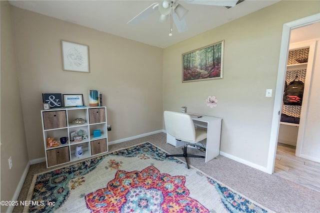 office with baseboards, carpet floors, and a ceiling fan