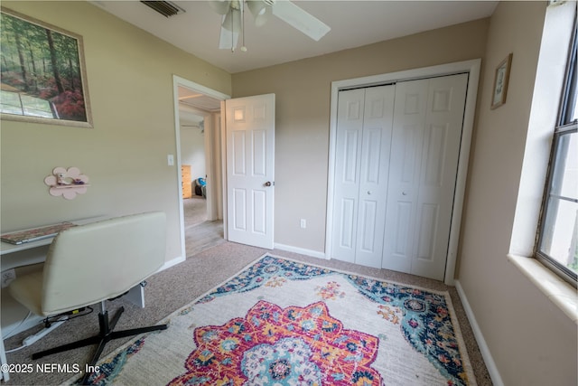 carpeted bedroom with baseboards, visible vents, a closet, and ceiling fan