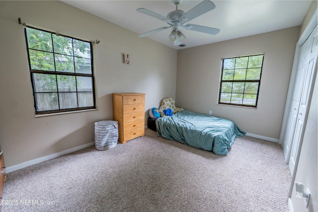 carpeted bedroom featuring baseboards, ceiling fan, and a closet