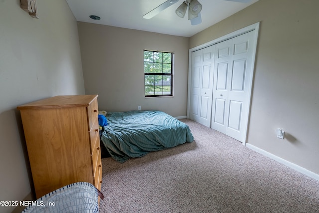 carpeted bedroom featuring baseboards, a closet, and ceiling fan