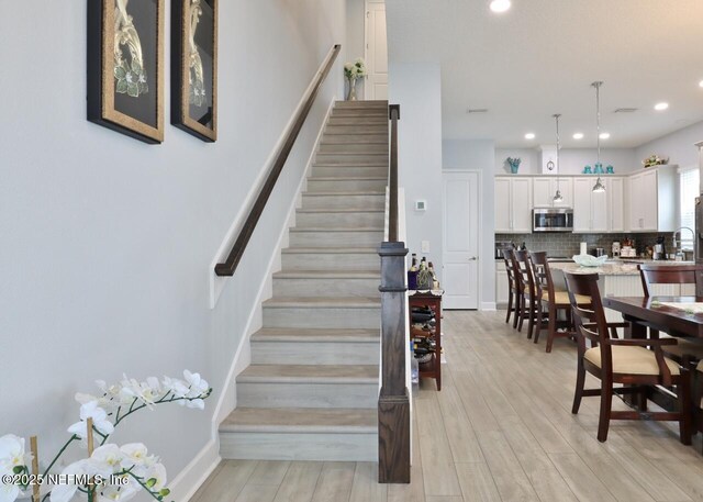 11466 Leatherback Ct, Jacksonville, FL 32256 - staircase featuring wood finished floors and recessed lighting