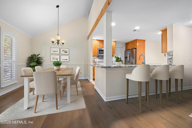 769 Sandy Oaks Ct, Ponte Vedra Beach, FL 32082 - dining room with dark wood-type flooring, a chandelier, baseboards, recessed lighting, and vaulted ceiling