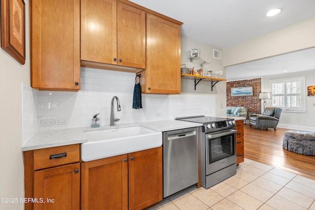 819 Lasalle St Unit 819, Jacksonville, FL 32207 - kitchen featuring a sink, appliances with stainless steel finishes, open floor plan, light tile patterned floors, and visible vents
