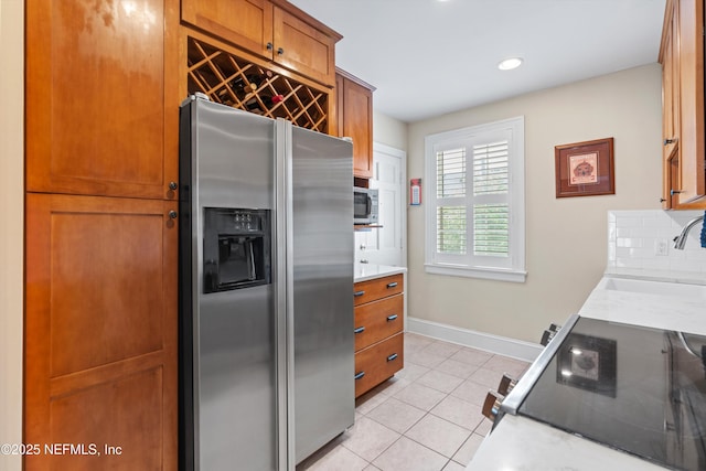 819 Lasalle St Unit 819, Jacksonville, FL 32207 - kitchen featuring light countertops, a sink, tasteful backsplash, light tile patterned floors, and stainless steel appliances
