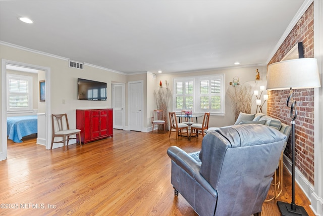 819 Lasalle St Unit 819, Jacksonville, FL 32207 - living area featuring visible vents, crown molding, light wood-style floors, and a wood stove