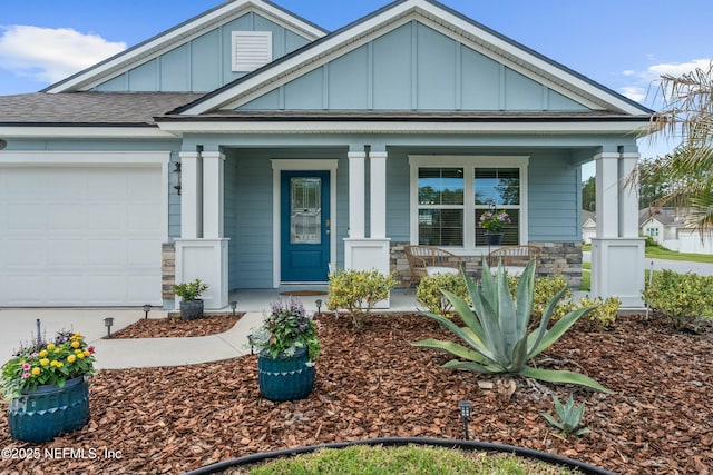 14 Balmoral Castle Dr, Saint Johns, FL 32259 - view of front facade with board and batten siding, a porch, an attached garage, and roof with shingles