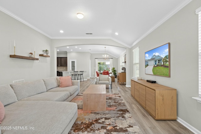 14 Balmoral Castle Dr, Saint Johns, FL 32259 - living area featuring baseboards, a chandelier, light wood-style flooring, visible vents, and arched walkways