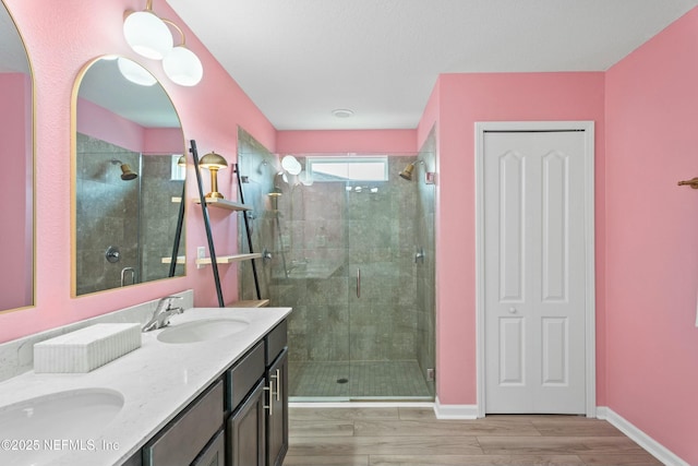 14 Balmoral Castle Dr, Saint Johns, FL 32259 - bathroom featuring a shower stall, double vanity, a sink, and wood finished floors