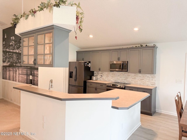 200 Nottingham Dr W, Saint Johns, FL 32259 - kitchen with stainless steel appliances, gray cabinets, decorative backsplash, light countertops, and recessed lighting