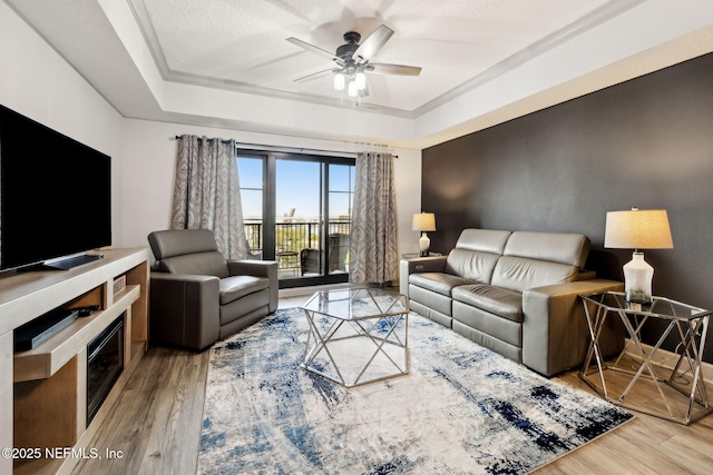 1478 Riverplace Blvd Unit 1103, Jacksonville, FL 32207 - living room with ornamental molding, a tray ceiling, ceiling fan, and wood finished floors