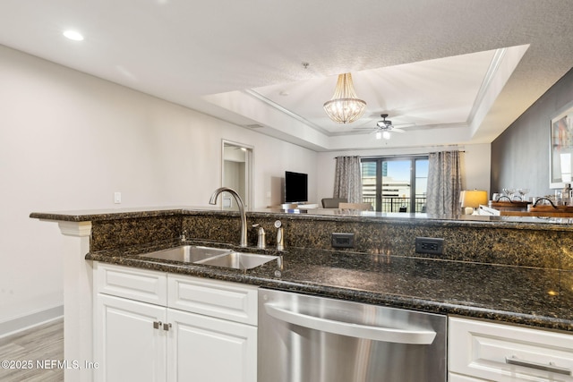 1478 Riverplace Blvd Unit 1103, Jacksonville, FL 32207 - kitchen with dishwasher, a sink, a tray ceiling, and dark stone countertops