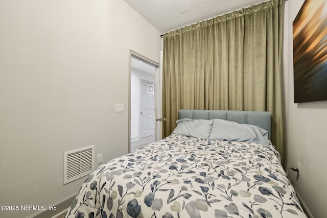 1478 Riverplace Blvd Unit 1103, Jacksonville, FL 32207 - bedroom featuring baseboards, visible vents, and a textured ceiling