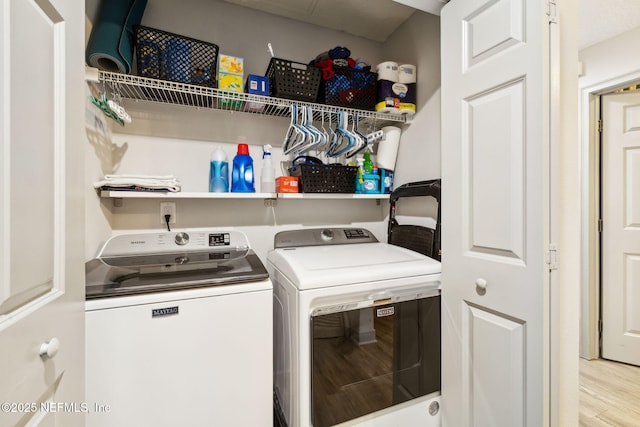 1478 Riverplace Blvd Unit 1103, Jacksonville, FL 32207 - laundry area featuring separate washer and dryer, wood finished floors, and laundry area