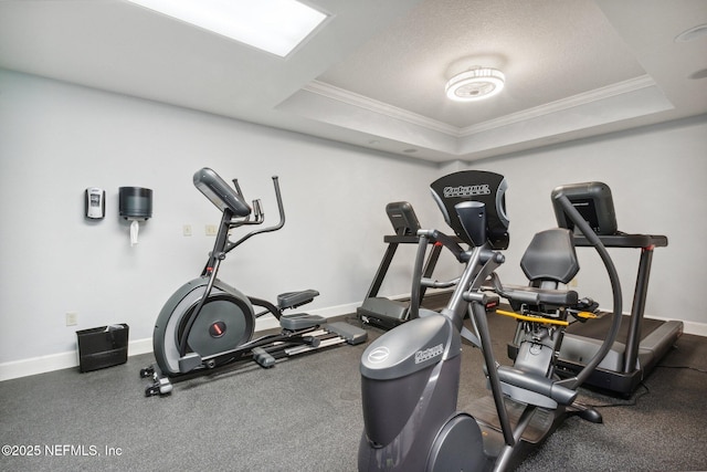 1478 Riverplace Blvd Unit 1103, Jacksonville, FL 32207 - exercise room featuring a raised ceiling, ornamental molding, and baseboards