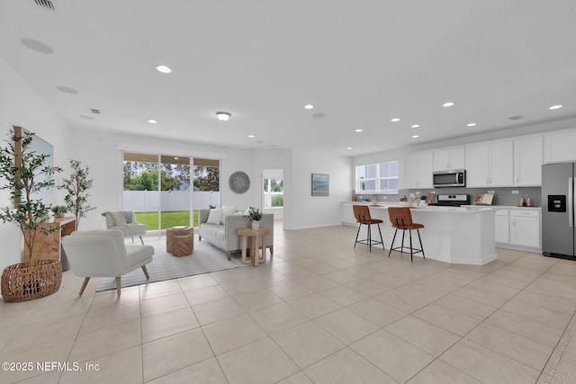 119 Cypress Banks Dr, Saint Johns, FL 32259 - living room with healthy amount of natural light, light tile patterned floors, and recessed lighting