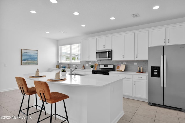 119 Cypress Banks Dr, Saint Johns, FL 32259 - kitchen featuring stainless steel appliances, light tile patterned floors, a center island with sink, white cabinets, and recessed lighting