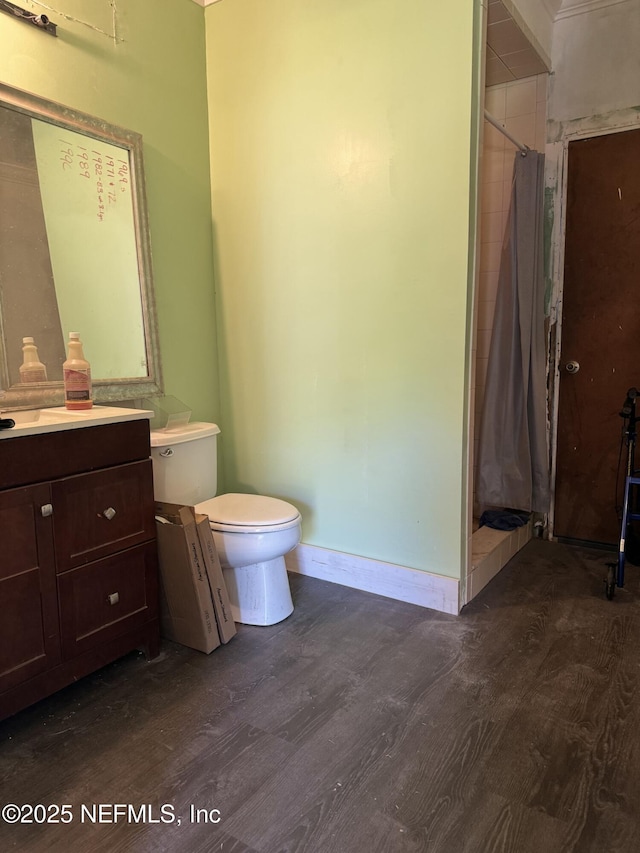 1103 Palm Cir, Jacksonville Beach, FL 32250 - full bathroom with toilet, baseboards, wood finished floors, a shower with shower curtain, and vanity