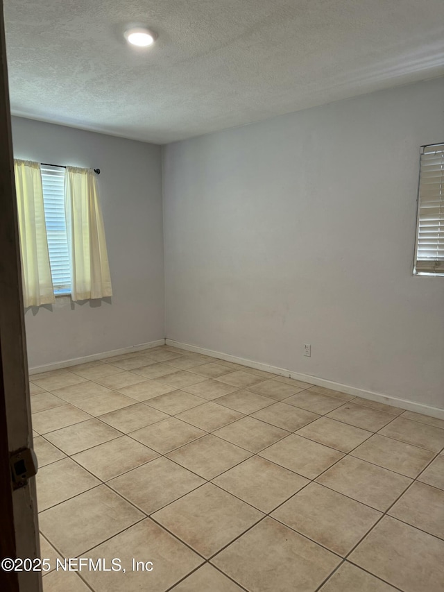 1103 Palm Cir, Jacksonville Beach, FL 32250 - unfurnished room with recessed lighting, baseboards, a textured ceiling, and light tile patterned floors