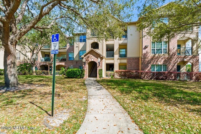 7800 Point Meadows Dr Unit 123, Jacksonville, FL 32256 - view of front of house featuring a front lawn and brick siding