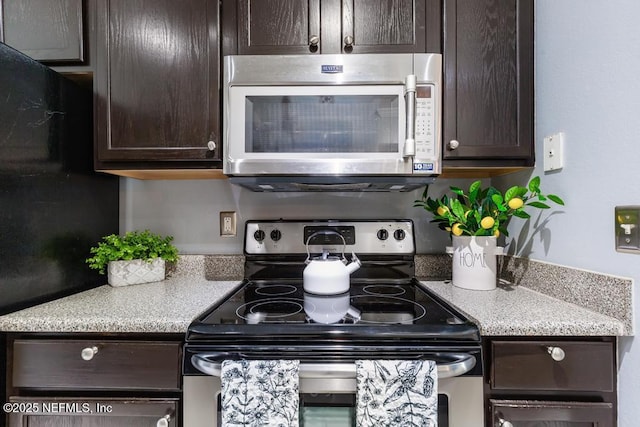 7800 Point Meadows Dr Unit 123, Jacksonville, FL 32256 - kitchen featuring dark brown cabinetry and appliances with stainless steel finishes