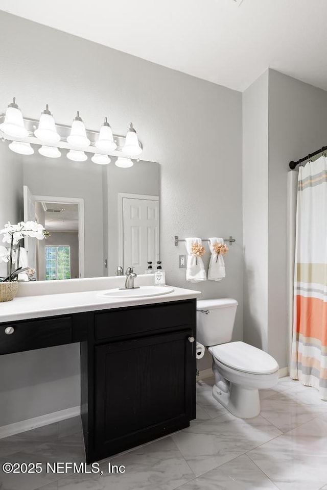 7800 Point Meadows Dr Unit 123, Jacksonville, FL 32256 - bathroom featuring marble finish floor, toilet, and vanity
