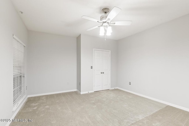 7800 Point Meadows Dr Unit 123, Jacksonville, FL 32256 - unfurnished bedroom featuring baseboards, carpet floors, a closet, and a ceiling fan
