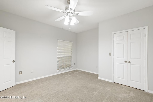 7800 Point Meadows Dr Unit 123, Jacksonville, FL 32256 - unfurnished bedroom with baseboards, carpet floors, a closet, and a ceiling fan