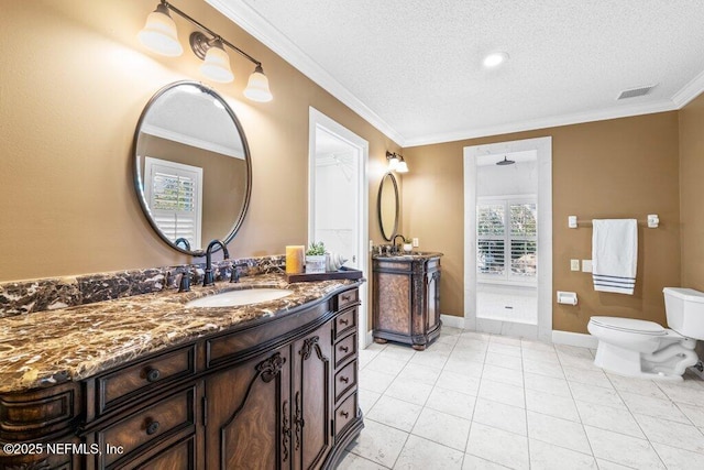 bathroom with a textured ceiling, visible vents, ornamental molding, toilet, and vanity