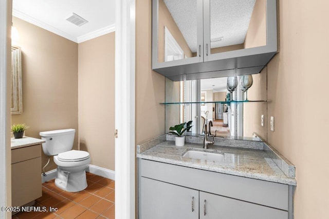 bathroom with visible vents, baseboards, toilet, vanity, and tile patterned flooring