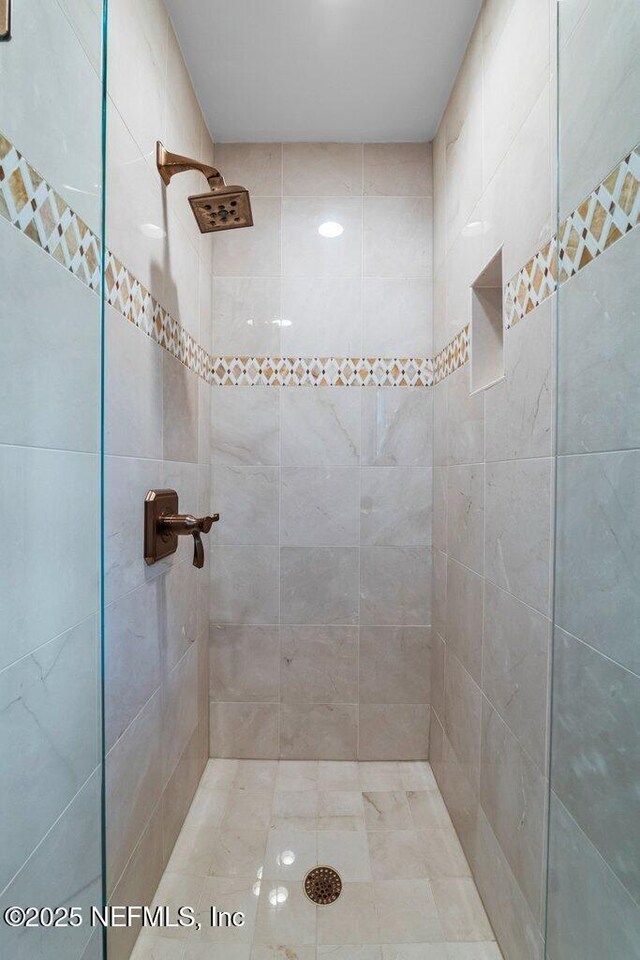 bathroom with tiled shower