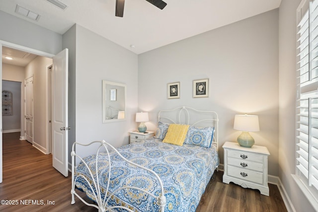 bedroom featuring visible vents, baseboards, a ceiling fan, and wood finished floors