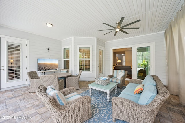 view of patio with an outdoor living space, ceiling fan, and outdoor dining area